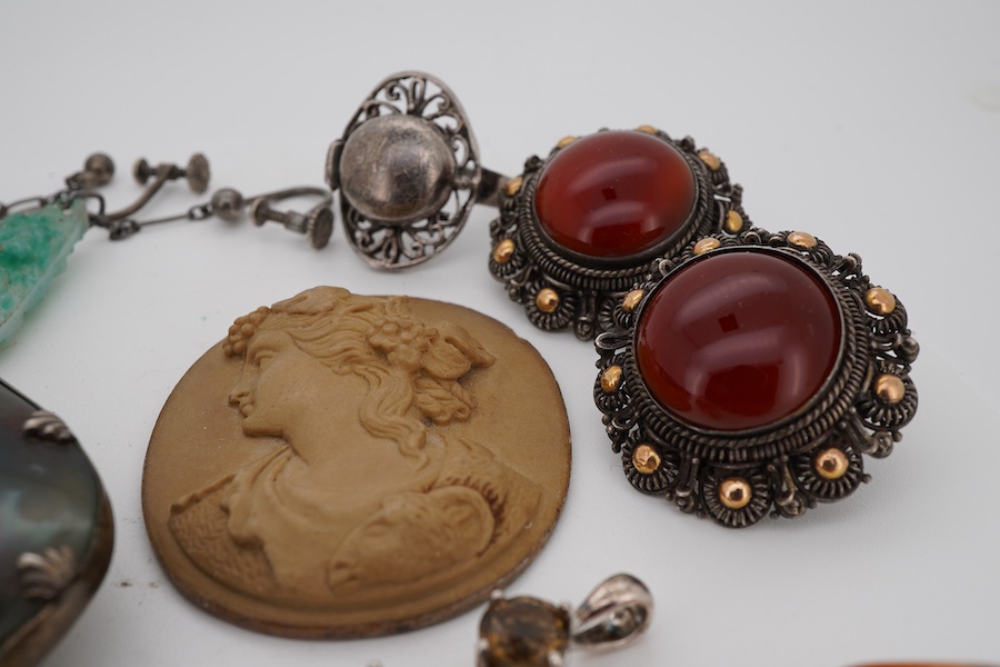 A small group of Victorian and later jewellery, including a white metal mounted bloodstone brooch, 57mm, lave cameo, rings, etc.